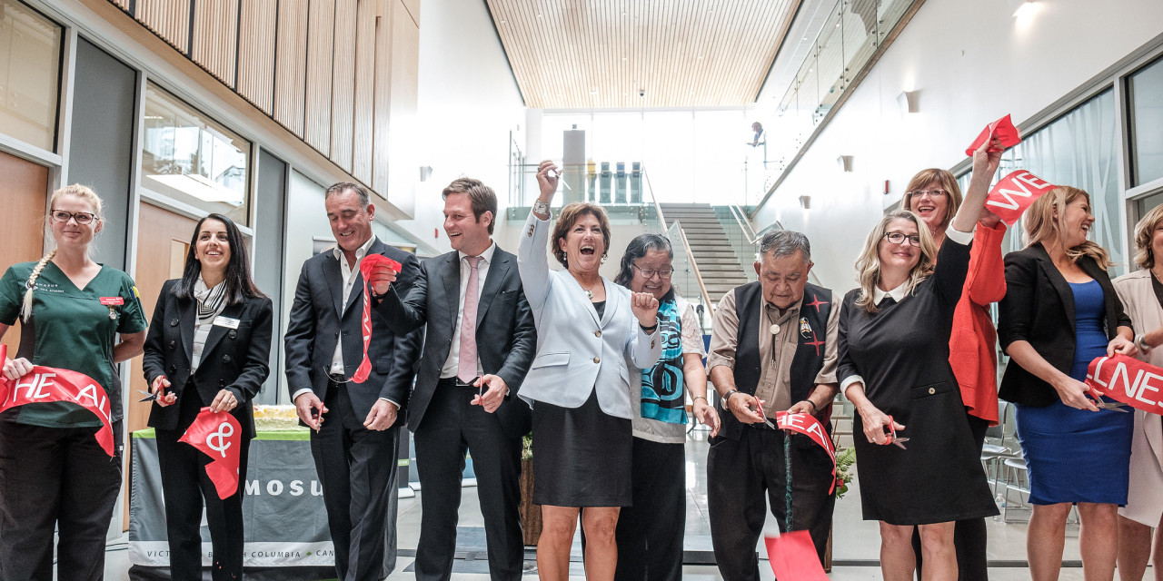 A group celebrates at as ߴý's President cuts giant red ribbon at in lobby of a brand new and very modern building. 