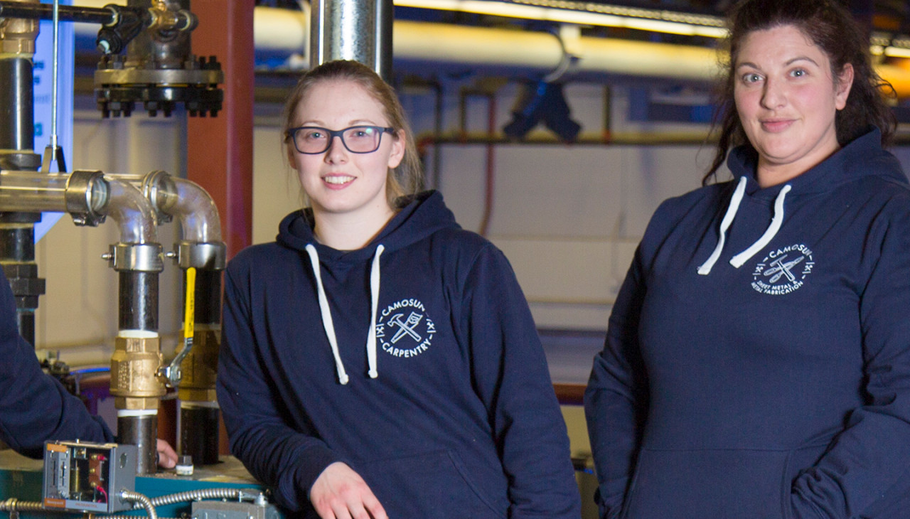 Two students sporting ߴý Carpentry Hoodies from the Bookstore